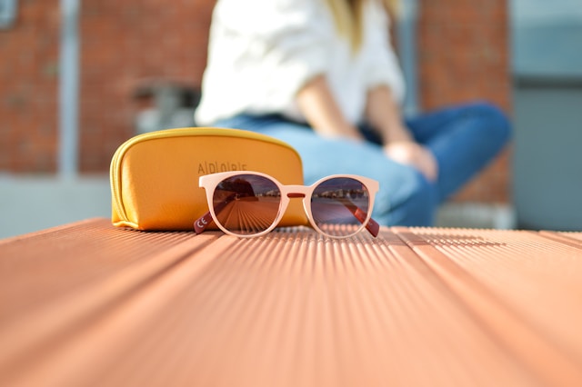 Person wearing designer sunglasses outdoors